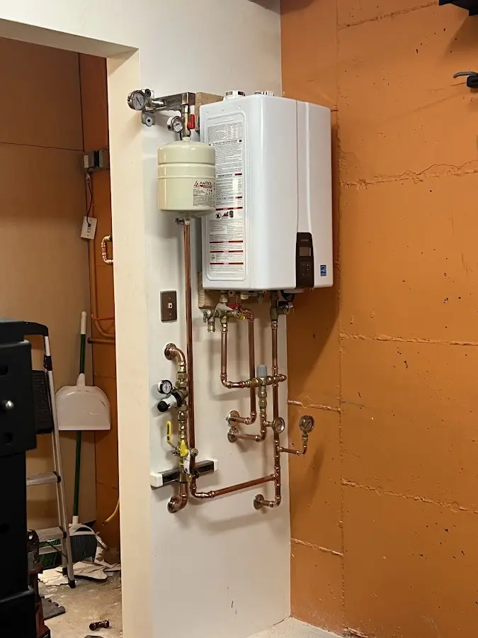 Plumbing technician inspecting water heater connections in Gainesville